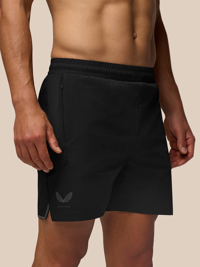 Side view of a man in black Apex Shorts with elastic waistband and a small logo on the left leg.