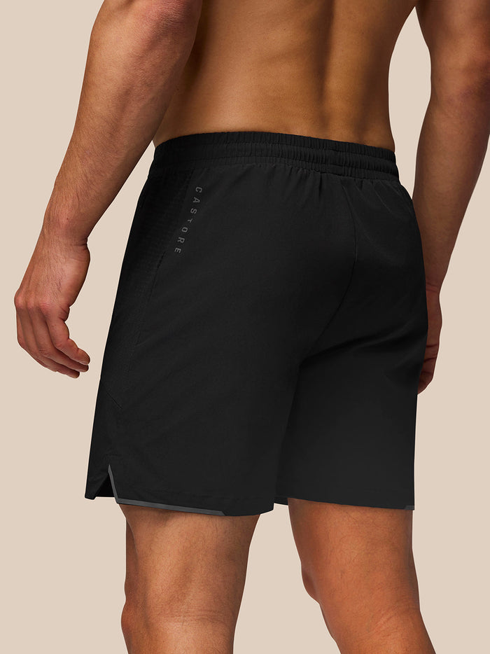 Back view of black Apex Training Shorts with elastic waistband; reflective Castore on right thigh and left rear, Protek on right rear.