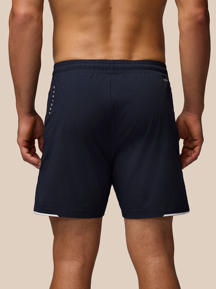Back view of navy Apex Training Shorts with elastic waistband and Castore branding along the left side