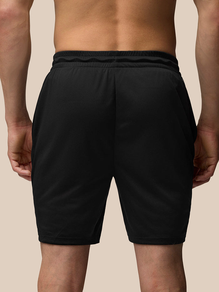 Rear view of black Adapt Training 7in shorts with elastic waistband and branding at the back.