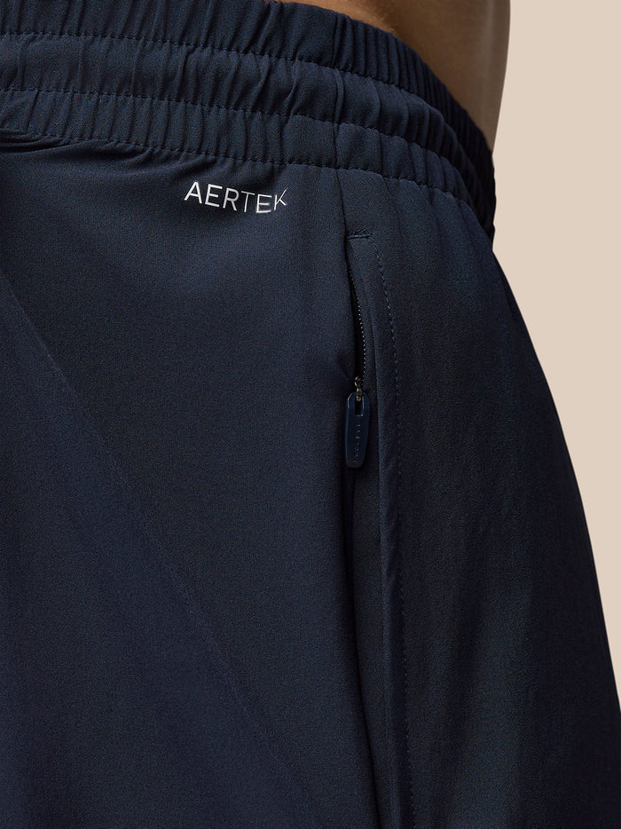 Close-up of navy Adapt Training 7 inch shorts waistband with AERTEK branding and a zip pocket.