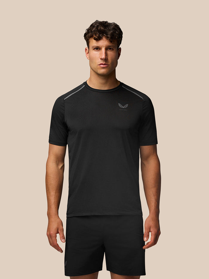 Male model in black Apex Training T Shirt with Aeromesh back panel and reflective branding.
