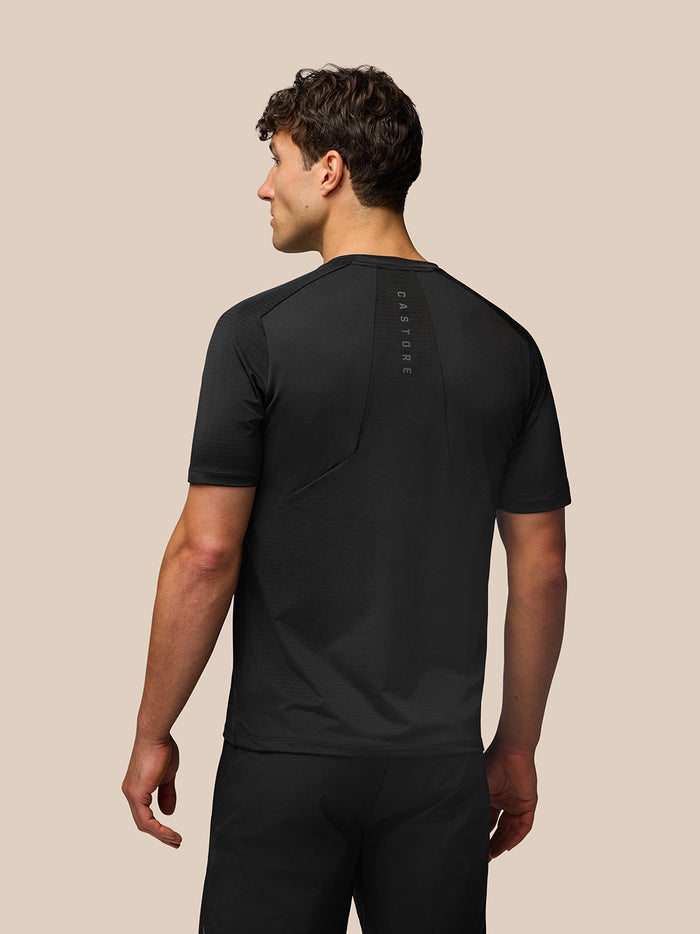 Back view of a male in black Apex Training T Shirt showing CASTORE branding down the spine.