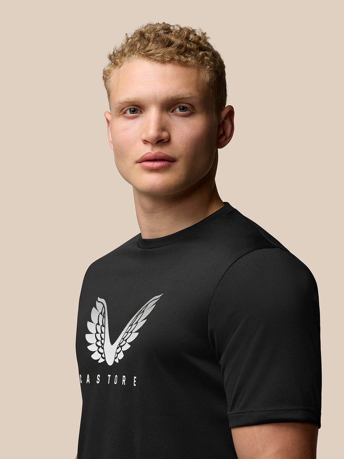 Male model wearing black Adapt Training T-Shirt with white Castore wings logo on chest.