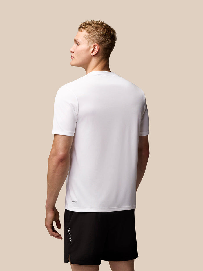 Side view of male model in white Adapt Training T Shirt showing wing graphic on chest