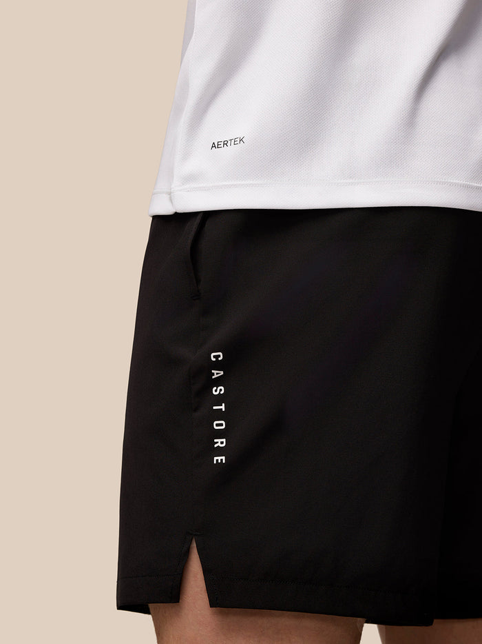 Side view detail of white Adapt T-Shirt showing Aertek branding on the lower back and CASTORE lettering on the shorts.