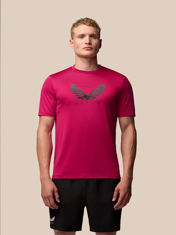 Front view of a male model wearing pink Adapt Training T-Shirt with Castore wings on the chest.