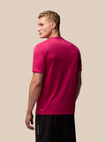 Back view of a male model wearing pink Adapt Training T-Shirt showing AerTek branding at the lower back.