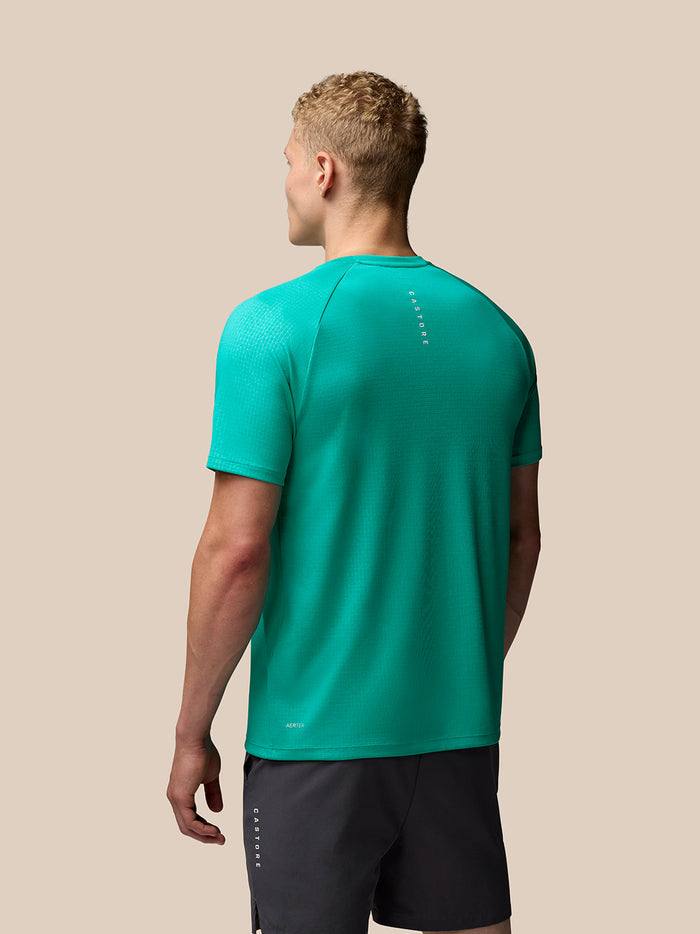 Back view of male model wearing Adapt Training T Shirt Dark Aqua with Castore branding down the back.