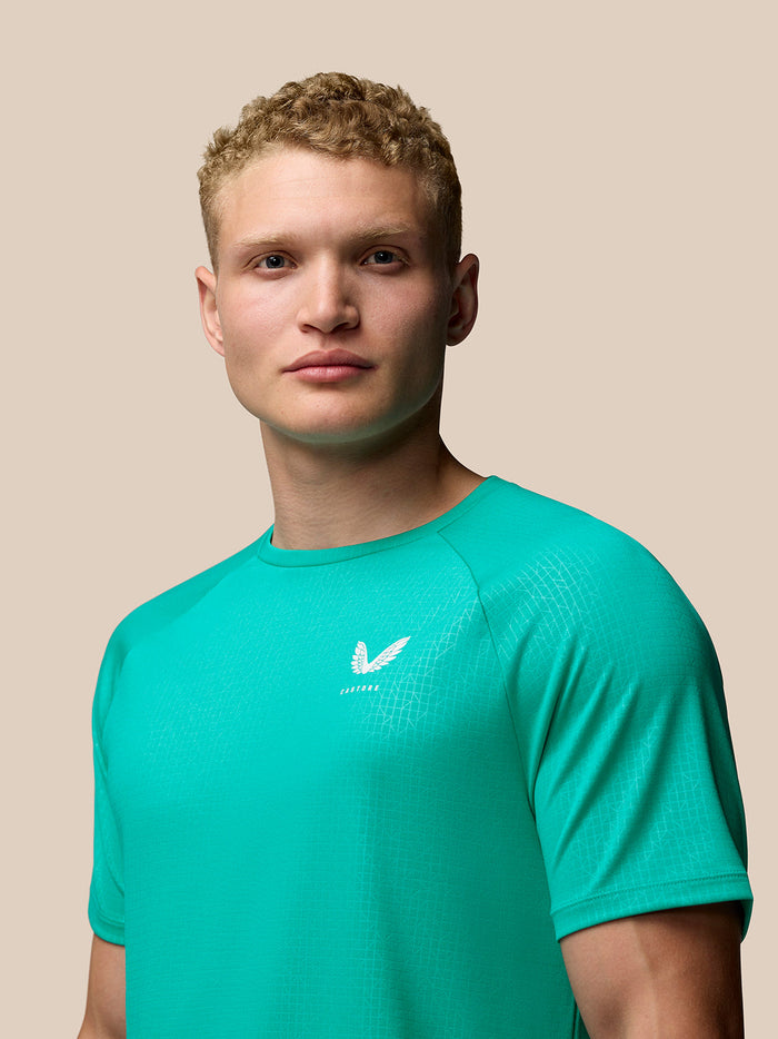 Front close up of teal Adapt Training T-Shirt highlighting crew neck and Castore logo on left chest