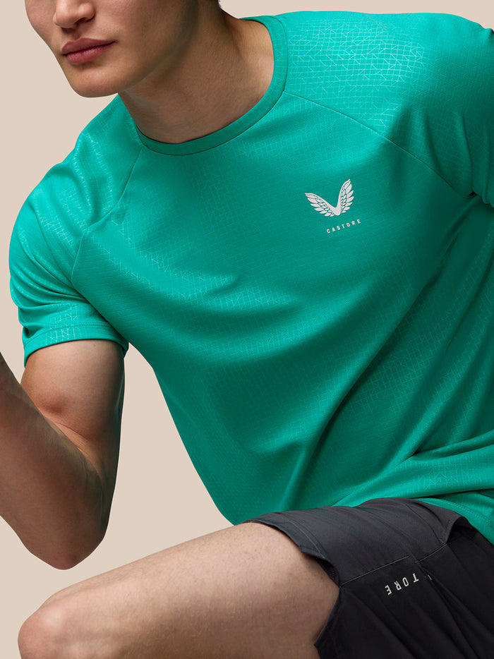 Front view of teal Adapt Training T-Shirt with left chest Castore logo and subtle geometric pattern across the fabric