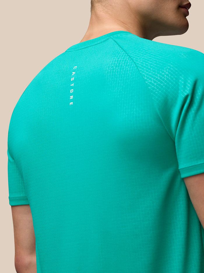 Back view of teal Adapt Training T-Shirt showing geometric shoulder pattern and vertical CASTORE branding along the upper back