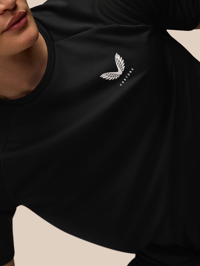 Close up of black Adapt Training T-Shirt with white Castore logo on left chest