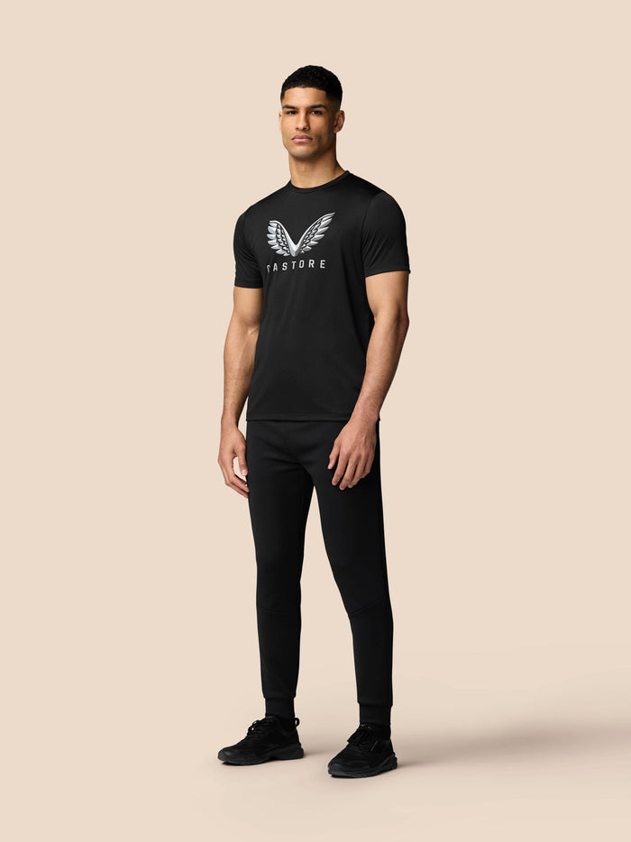 Three-quarter rear view of black athletic T-Shirt with subtle branding at back hem