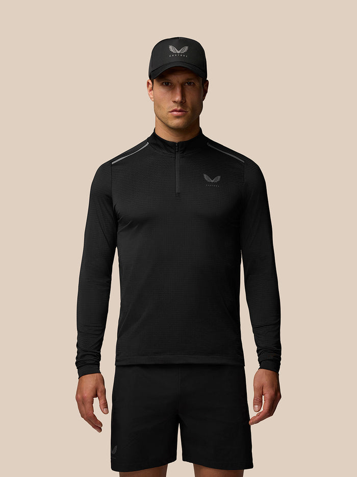 Male model wearing black Apex Training Quarter Zip Top with stand collar and chest logo