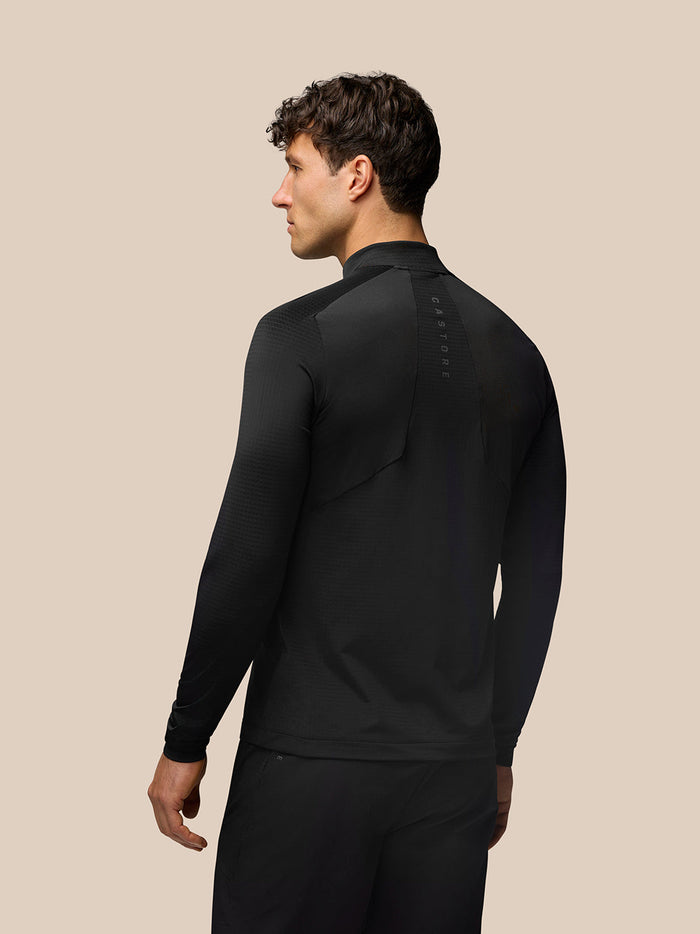 Back view of a man wearing black Apex Training Quarter Zip Top with Aeromesh branding along the back.