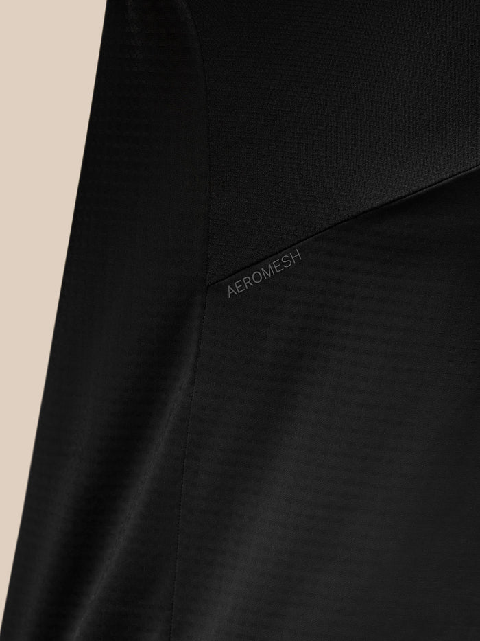 Close-up of the black Apex Training Quarter Zip Top showing Aeromesh panel detail along the shoulder.