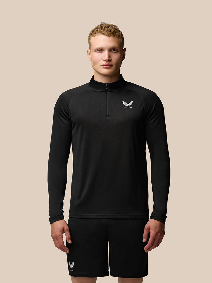Male model wearing black Adapt Training Quarter Zip Top with stand collar and front zip, front view