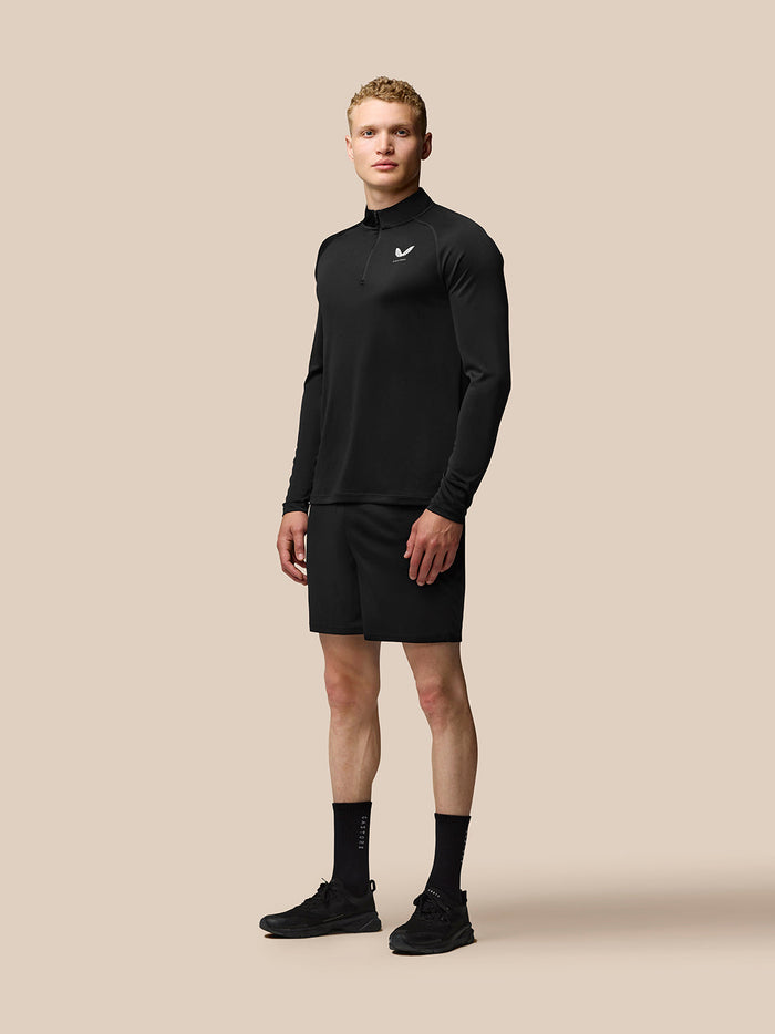 Male model wearing black Adapt Long Sleeve Lightweight Quarter Zip Top with stand collar and chest logo