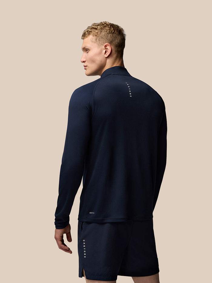 Back view of midnight navy Adapt Training Top showing vertical Castore branding along the upper back