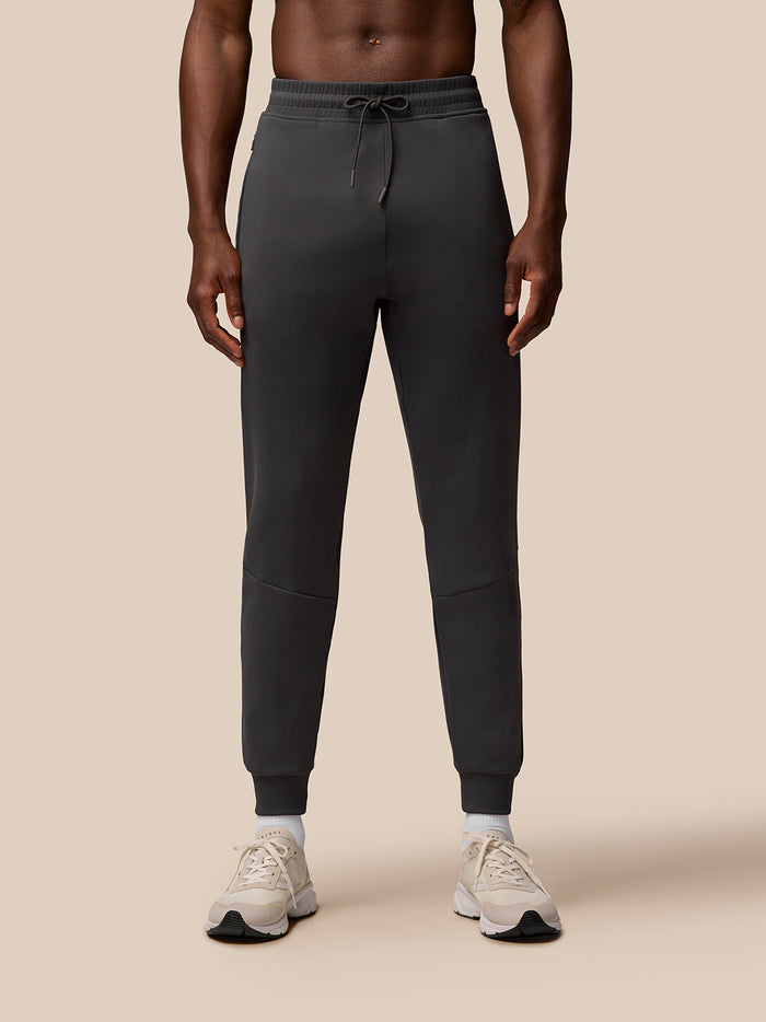Front view of a man wearing Charcoal Flex Joggers with a drawstring waist and self fabric cuffs