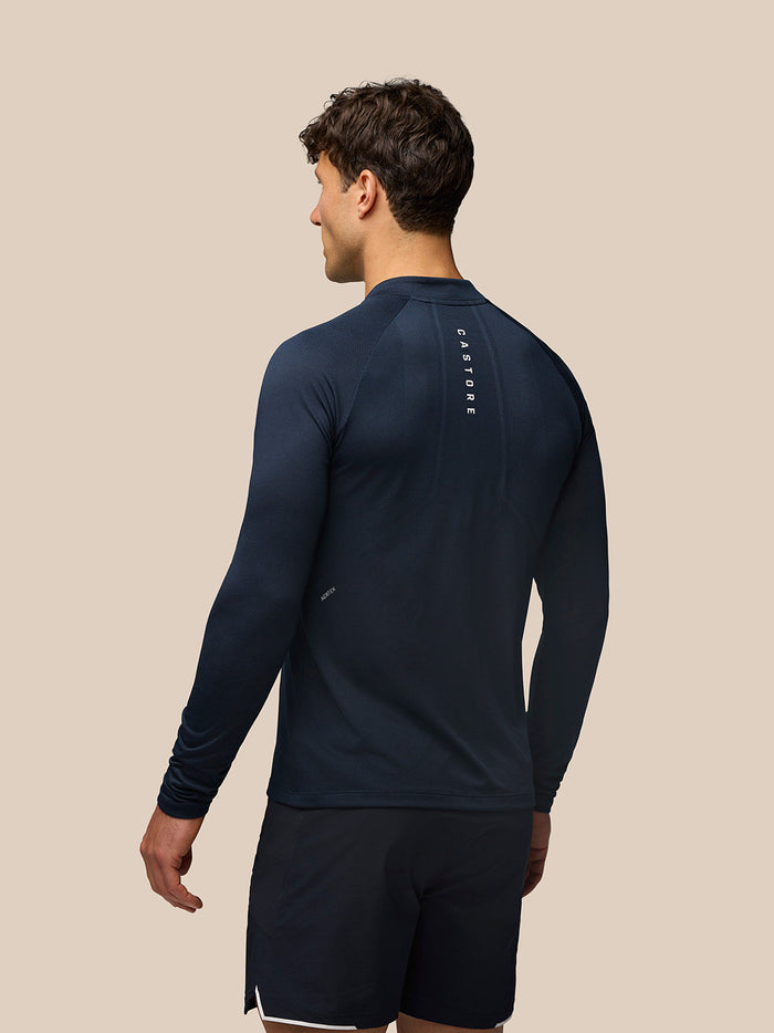 Back view of Apex Long Sleeve Engineered Knit Quarter Zip Top in Midnight Navy with CASTORE branding along the upper back