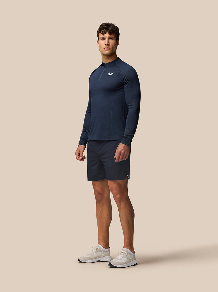 Male model wearing Apex Training Quarter Zip Top in midnight navy with stand collar and center zip