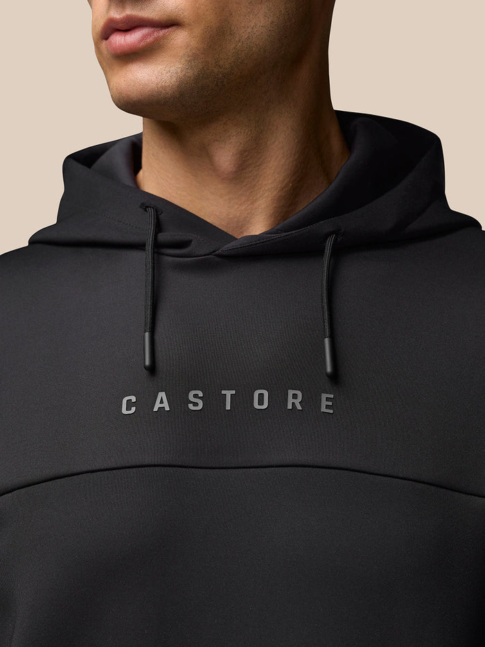 Close-up of a black Flex Hoodie showing drawstrings and CASTORE branding on the chest