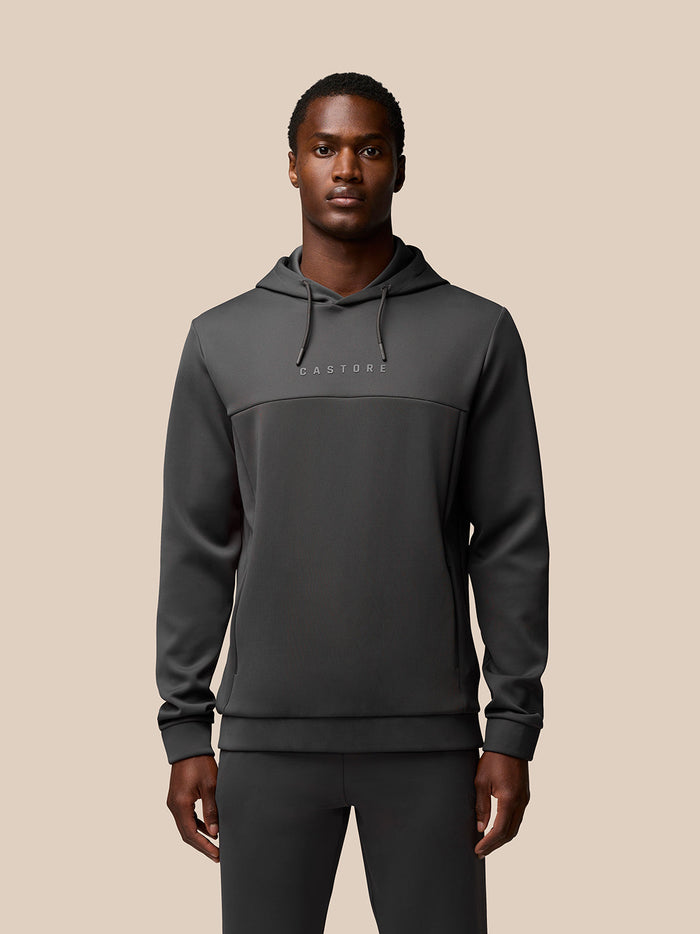 Front view of charcoal Flex Lifestyle Hoodie on a male model, featuring CASTORE logo on the chest and a drawstring hood.