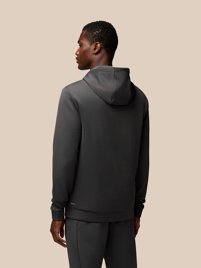 Rear view of charcoal Flex Lifestyle Hoodie on a male model with a hood and Protek branding at lower back.