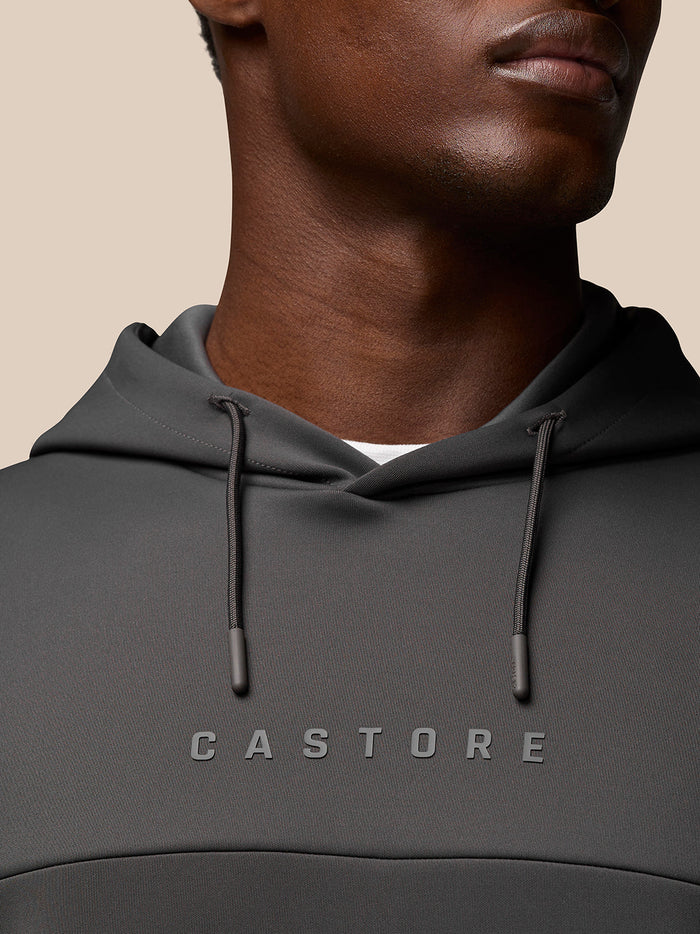 Close-up of a man wearing the Charcoal Flex Lifestyle Hoodie, highlighting the Castore chest logo and the drawstring hood.
