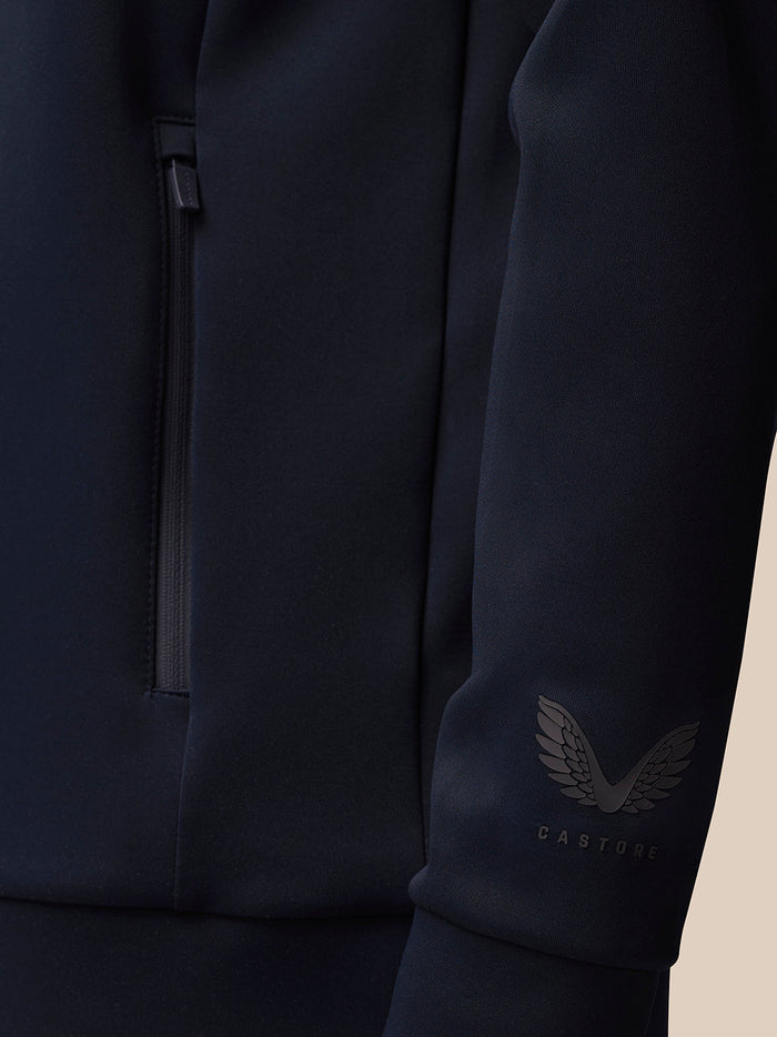 Navy sleeve close-up with wing Castore logo and CASTORE text near the cuff