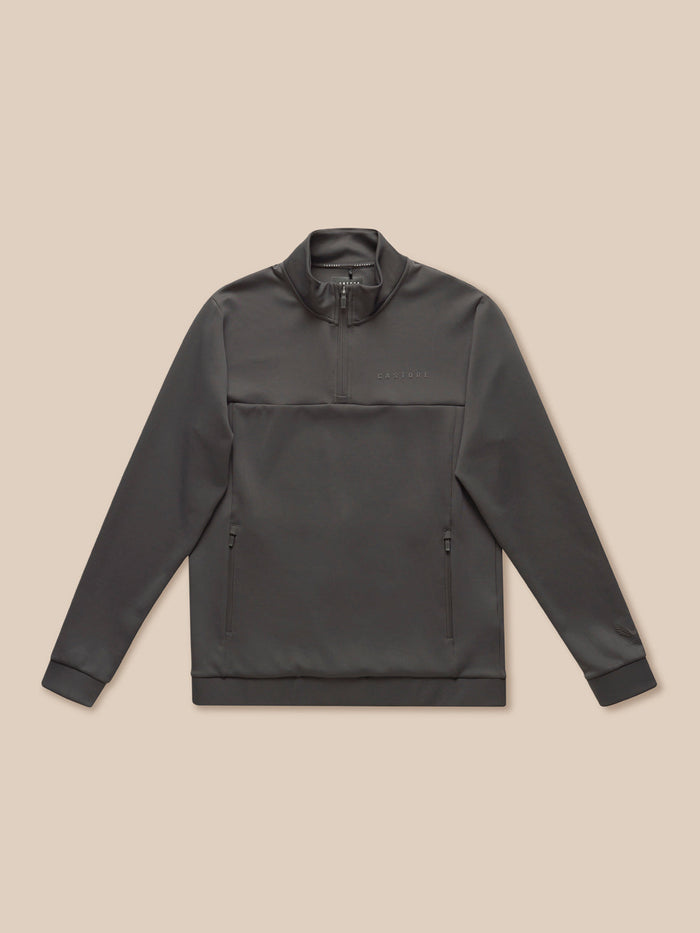 Front view of charcoal Flex Lifestyle 1/4 Zip top with stand collar and zip pockets, Castore branding on chest.