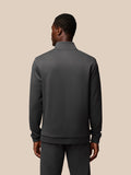 Back view of a man wearing a charcoal Flex Lifestyle 1/4 Zip top with a clean silhouette and ribbed hem.