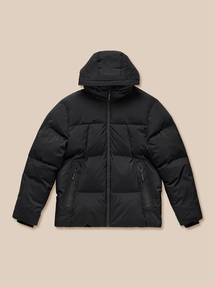 Front view of a black puffer jacket laid flat showing full zip and zipped pockets with Castore branding on chest