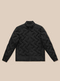 Close-up of black quilted fabric texture with a subtle grid pattern