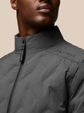 Close-up of charcoal Quilts Lifestyle Jacket with stand collar and front zip showing Castore branding on sleeve