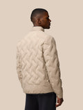 Back view of beige Mushroom padded jacket on a man, showing quilted pattern