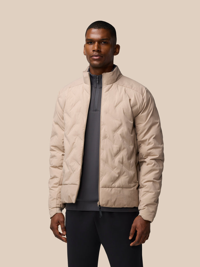 Male model wearing Mushroom padded jacket with zip pockets in front view