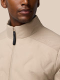 Close-up of a mushroom colored padded jacket collar with a zipper and CASTORE branding