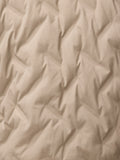 Close-up of mushroom beige fabric with a fine grid texture for the padded jacket