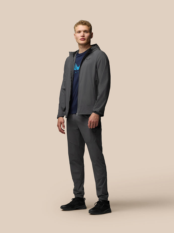 Male model wearing charcoal Lightweight Flex Jacket with hood and full front zip