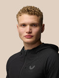 Close-up of a model wearing the black Flex Winterised Jacket with front zip and Castore logo on the chest