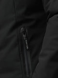 Close-up of black longline jacket showing waterproof zipper pull with Castore branding.