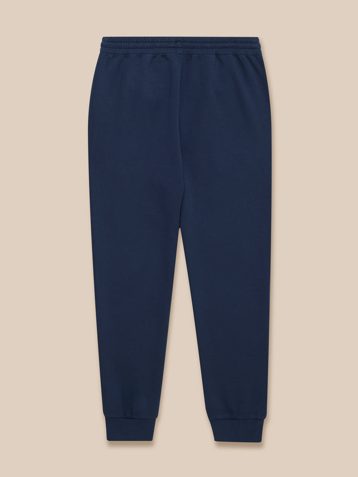 Back view of navy men's Travel Lifestyle Joggers with an elastic waist and cuffed hems