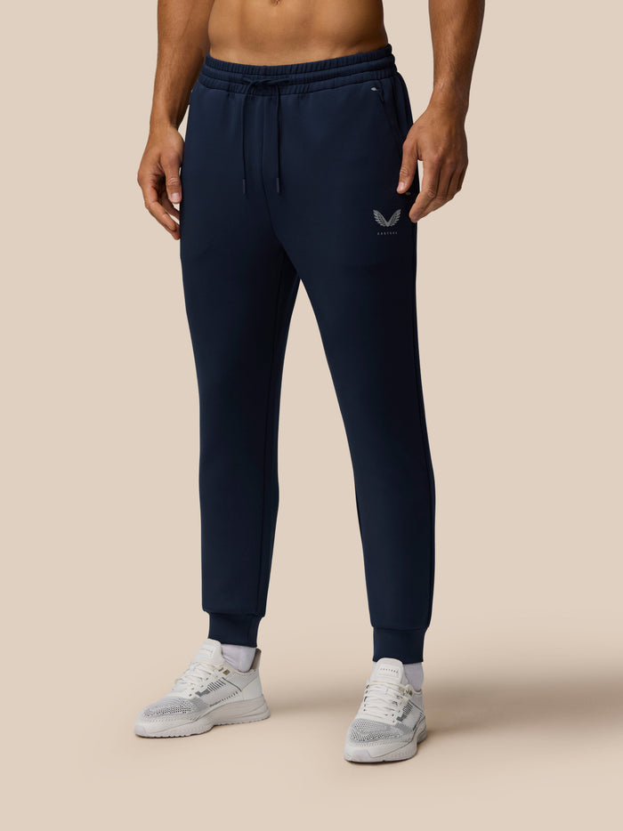 Navy Travel Lifestyle Joggers with drawstring waist, tapered leg, concealed zip pocket, and Castore logo on the thigh.