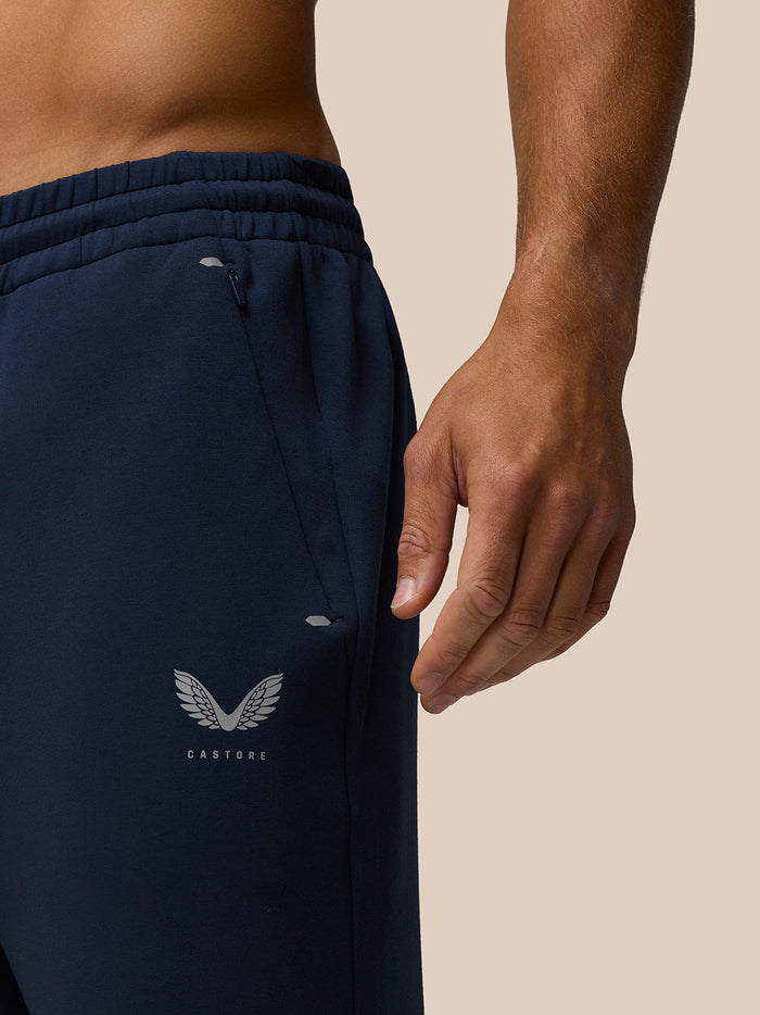 Close-up of navy Travel Joggers waistband with elastic and internal drawcord and Castore logo on the leg.