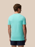 Back view of a man wearing the light aqua Zone Training T-Shirt on a beige background