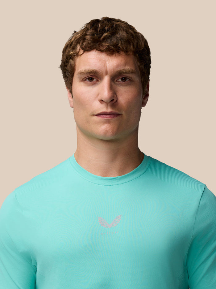 Close-up of male model wearing Light Aqua Zone Training T-Shirt highlighting fit and small chest logo