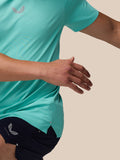 Close-up of torso in light aqua Zone Training T-Shirt, showing chest logo and curved hem.